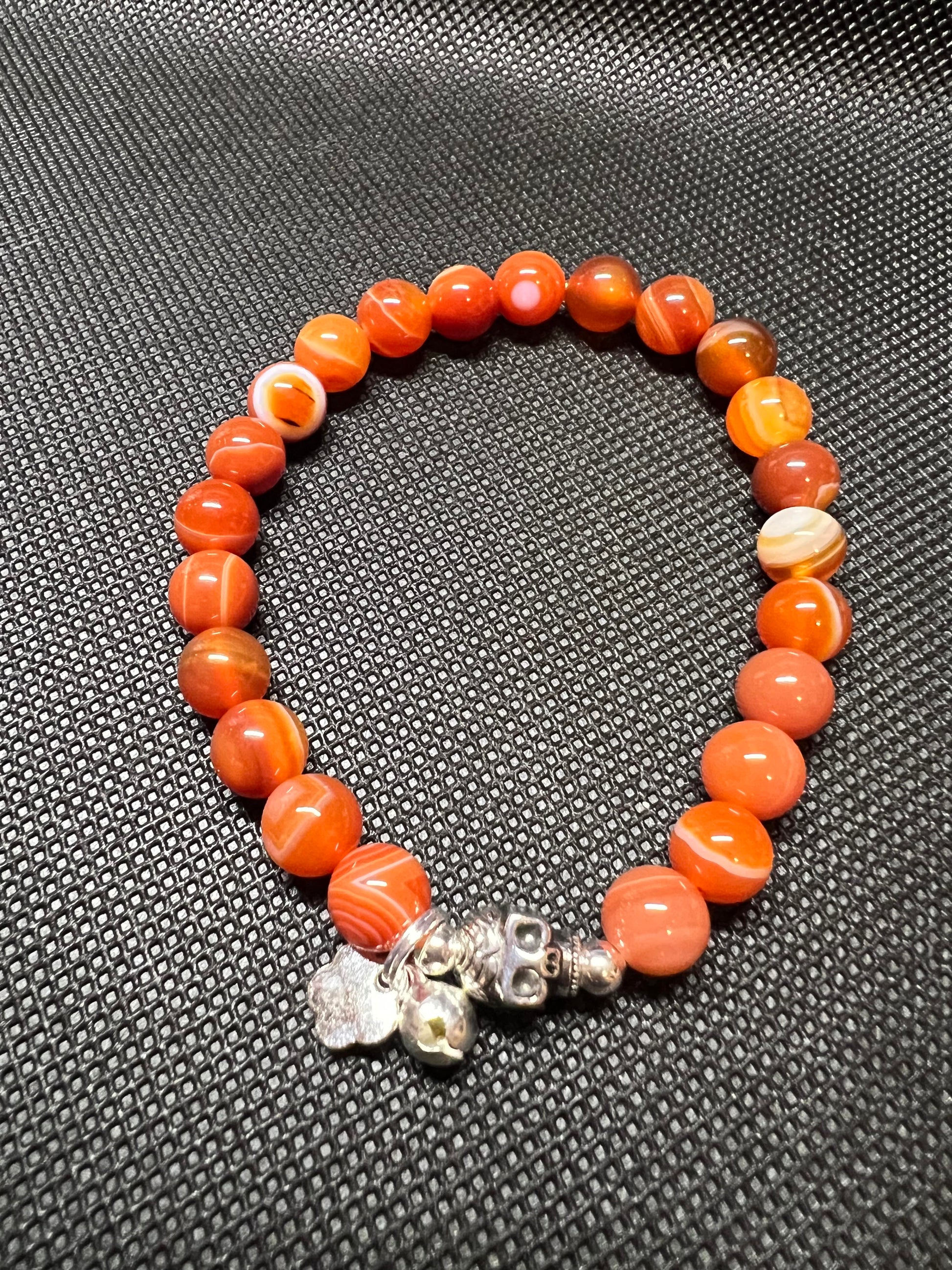 Sardonyx Beads 8mm with silver skull, spacers and charms.